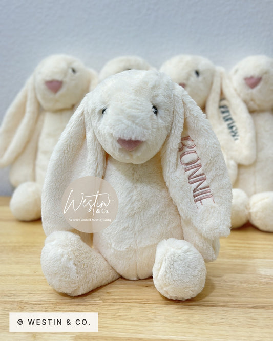 Personalized embroidered plush bunny in ivory with a name stitched on the ear