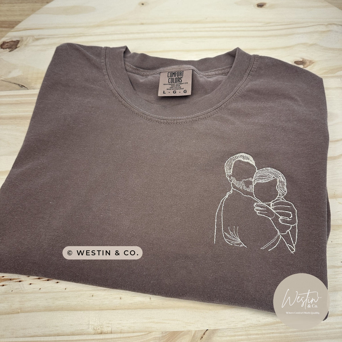 Custom embroidered line art portrait of a couple on a brown Comfort Colors tee